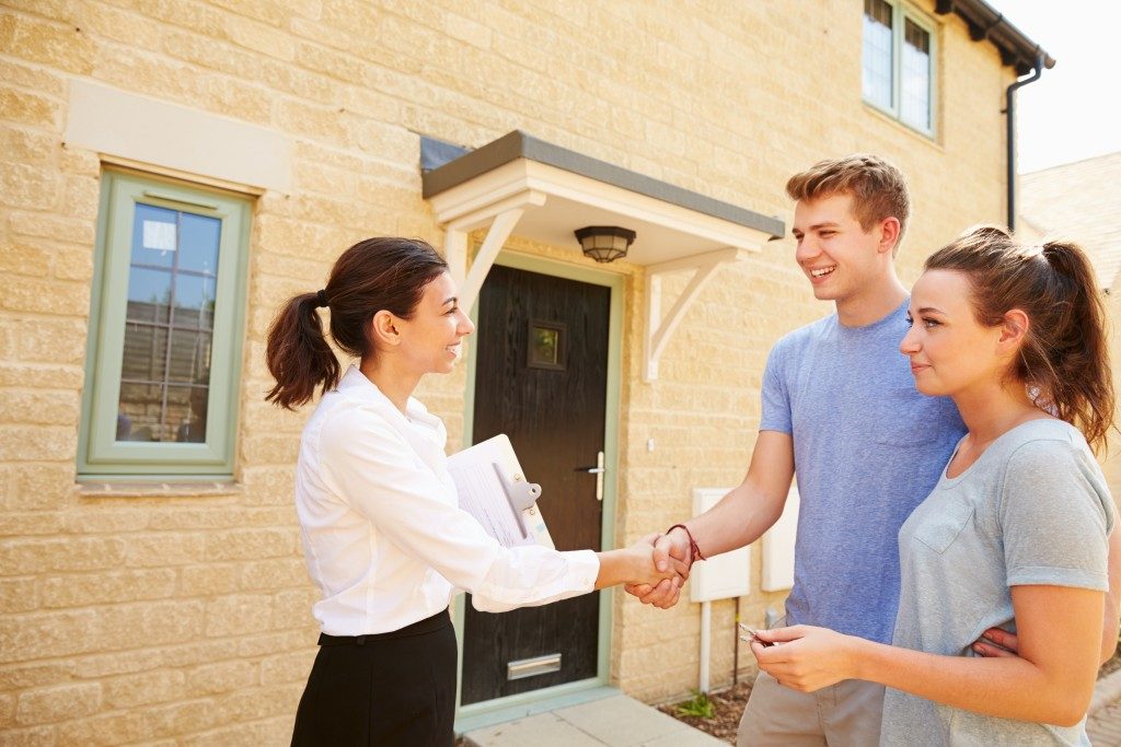 Agent shaking hands with new property owner