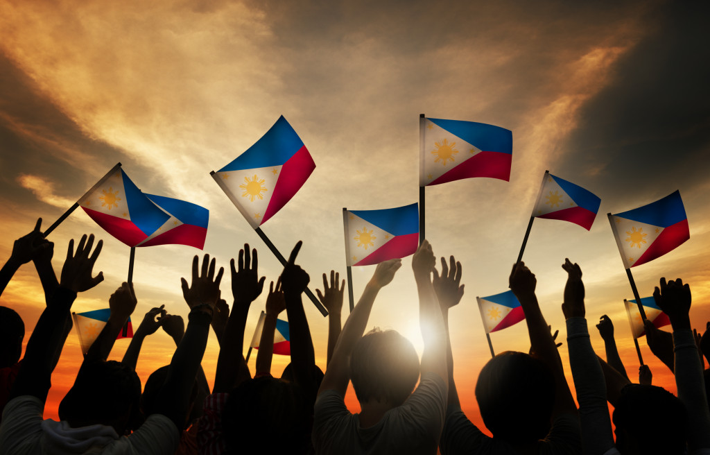 people raising Philippine flag
