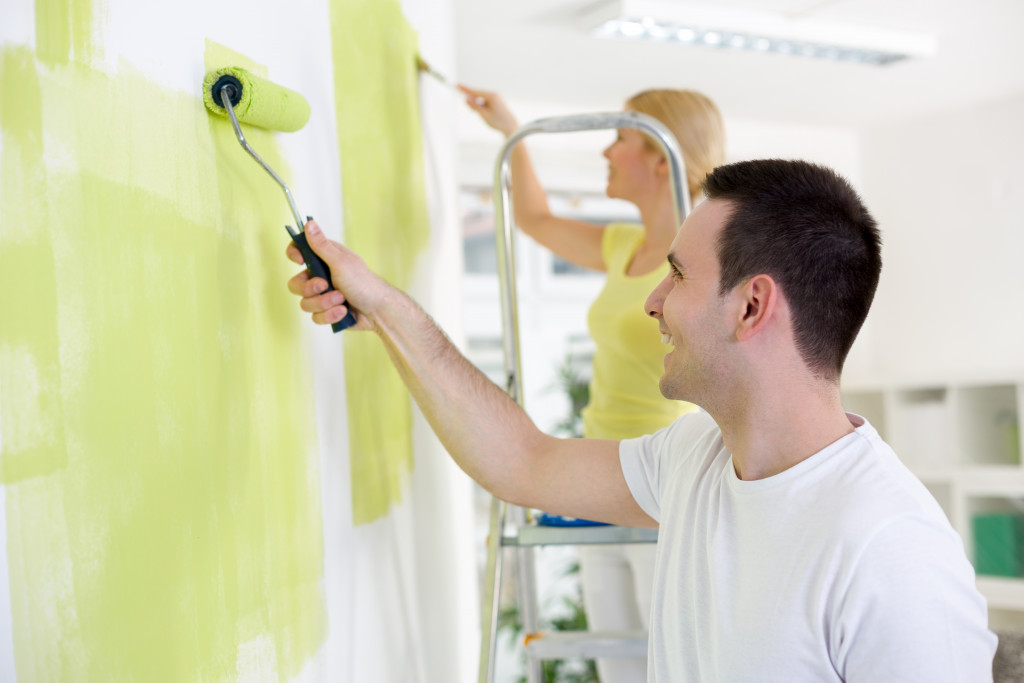 a couple repainting a room